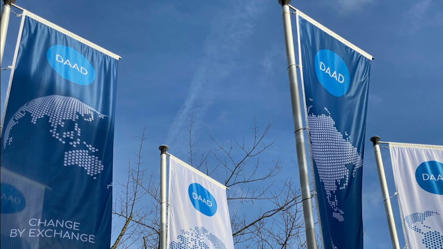 DAAD flags against a blue sky